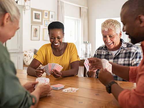 Gather with friends and neighbors for a game of cards.>